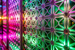 Close-up of Glass Partition with Frosted Geometric Patterns on Neon Pink and Green Background
