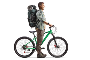 Poster - Full length profile shot of a man with a backpack standing with a bicycle