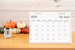 May Desktop calendar for 2024 year and heap pumpkins with clock.