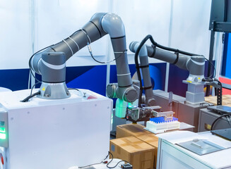 Wall Mural - robot arm with test tube for biological experiments in laboratory