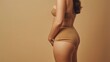 © OMD - Side profile of a woman wearing nude shapewear against a plain background.
