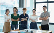 © SOMKID - Asia young creative people in smart casual wear looking at camera in office workplace.
