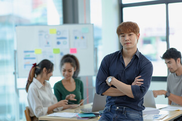 Wall Mural - Asia young creative man in smart casual wear looking at camera in office workplace.