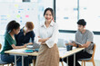 © SOMKID - Asia young creative people in smart casual wear looking at camera in office workplace.