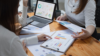 Technology and financial advisory services concept. Business teamwork and working on digital laptop computer with advisor showing plan of investment to clients at table office. Digital marketing.