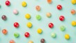 Colorful candies on white and green background. Flat lay