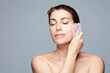 Radiant Woman Using Gua Sha Tool For Facial Skin Care