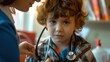 A caring pediatrician examines a young boy with a stethoscope during a routine health check-up in a clinic..