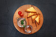 Homemade turkey or chicken liver pate in a glass jar. Baguette slices. Cherry tomatoes on a wooden round board. Top view.