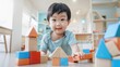 © iuricazac - Young child with a joyful expression sitting on the floor in a playroom filled with colorful wooden blocks engaging in imaginative play.
