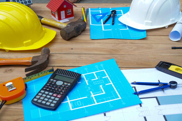 Architectural plan in top view of engineer at wooden table