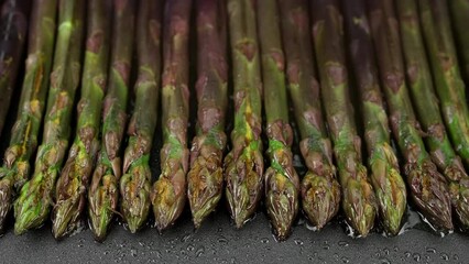 Wall Mural - Process frying purple asparagus in electric grill
