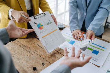 Close up of Business team analyzing income charts and graphs with modern laptop computer. Business analysis and strategy concept.