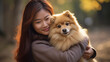 Pomeranian dog hug by a woman