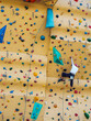 Man practicing Rock climbing wall bouldering Indoor Active lifestyle