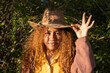 © VISTA by Westend61 - Young woman with curly hair wearing cowboy hat