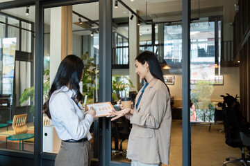 Wall Mural - Employee business woman talking, consulting, exchanging idea, asking for advice from manager