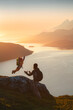 © EVERST - Father and child traveling together summer vacations, kid jumping playing with dad hiking in Norway adventure trip healthy lifestyle happy emotions outdoor sunset fjord and mountains view