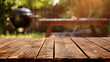 Empty wooden table for grilled barbeque at country house yard