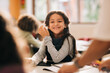 © Jacob Lund - Happy little girl sitting in class, young student enjoying elementary school
