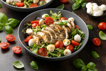 Wall Mural - Chicken caprese salad with tomato, mozzarella and balsamic dressing