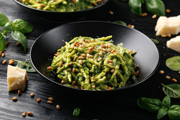 Wall Mural - Trofie pasta with creamy spinach sauce and toasted pine nuts