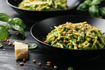 Wall Mural - Trofie pasta with creamy spinach sauce and toasted pine nuts