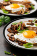 Mushrooms and fried eggs on toast with herbs breakfast