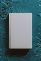 Vertical white book on a textured teal background