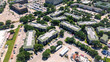 Top view dense of office buildings, hotels, restaurants with ample parking spaces in urbanized zones Northwest Dallas business park, Love Field neighborhood, lush green tree cover, aerial view