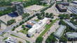 Top view dense of office buildings, hotels, restaurants with ample parking spaces in urbanized zones Northwest Dallas business park, Love Field neighborhood, lush green tree cover, aerial view