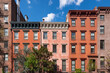 Row of townhouses with red brick facades in Chelsea Historic District. Manhattan, New York City