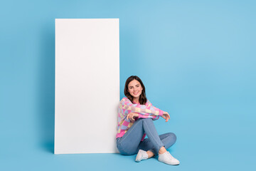 Poster - Full length photo of young pretty woman good mood sit floor advert isolated over blue color background