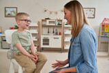 Fototapeta  - Little boy and therapist in the classroom