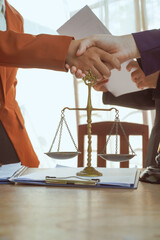 Shaking hands, A group of lawyers and clients engage in a professional meeting at a law office, discussing agreements, contracts, and legal matters with a focus on justice and expert advice.