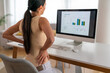 Tired woman worker sit at desk touch back suffer, woman strong backache, incorrect posture concept
