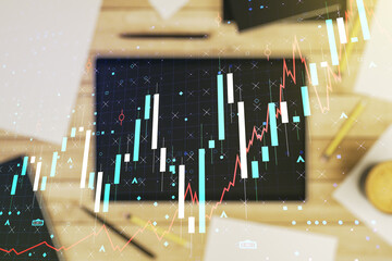 Poster - Abstract creative financial graph and modern digital tablet on desktop on background, top view, financial and trading concept. Multiexposure