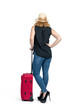 A happy woman in a straw hat, jeans, and high-heeled shoes stands with a red suitcase, back view. Without a face. Isolated on a white background