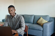 Young African businessman working from home using a laptop