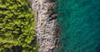 TOP DOWN: Scenic view of Mediterranean vegetation, rocky beach and turquoise sea