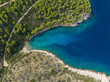 AERIAL TOP DOWN: Breathtaking view of a secluded rocky beach in verdant Dalmatia