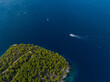 AERIAL: Sailboat and yacht meet while explore the deep blue seas of the Adriatic