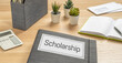 A folder on a desk with the label Scholarship