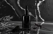Mockup with cosmetic serum dropper bottle from transparent glass on black marble background. Dark mood concept. Essential oil from lavender flowers.