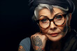 Portrait of elegant cheerful tattooed elderly woman with stylish clothes. Tattoo art, aging, maturing, longevity, lifespan, healthy living, fulfilling life, senescence, gerontology, anti-aging concept