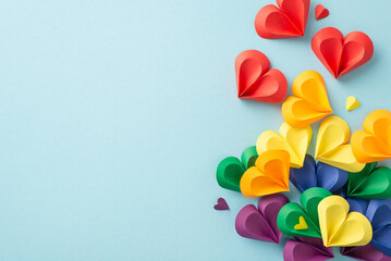 Sticker - An artistic arrangement of colorful paper hearts in rainbow colors represents love and diversity for Pride Month on a subtle gray background