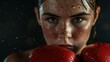Close-up portrait of young woman boxer wearing red boxing gloves