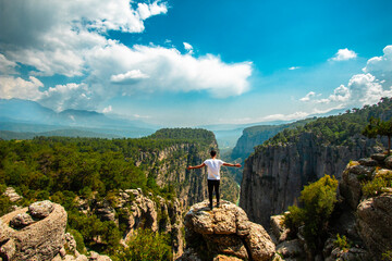Poster - Man opens his arms and watches the fascinating nature view. The magnificence and majestic cliffs of Tazi Canyon. View of the valley from above. Antalya Turkey..