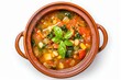 Minestrone soup in tarracotta bowl on white background