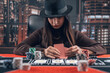 serious young woman playing poker, think and bet
